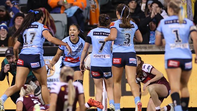 Tiana Penitani of the Blues celebrates scoring a try which was disallowed after review.