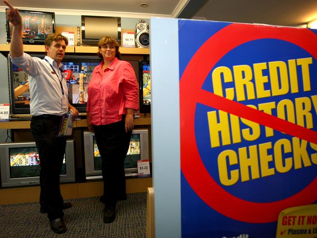 Radio Rentals store manager Jamie Annable explains product features and finance packages to customer Amanda Richardson at the Radio Rentals at their Fortitude Valley store in Brisbane.