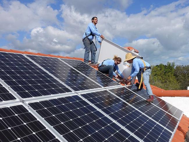 Workers install solar panels on a rooftop at a home in Palmetto Bay, Fla. New EPA regulations due out Monday will encourage more use of renewable energy. PHOTO: KERRY SHERIDAN/AGENCE FRANCE-PRESSE/GETTY IMAGES