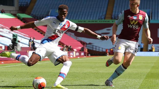 Wilfried Zaha battles for possession with Matt Targett of Aston Villa.