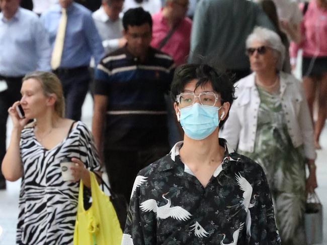 18 March 2018, A man with shopping and face mask, face masks being worn for Corona virus, Queen Street Mall, Brisbane. Photographer: Liam Kidston.