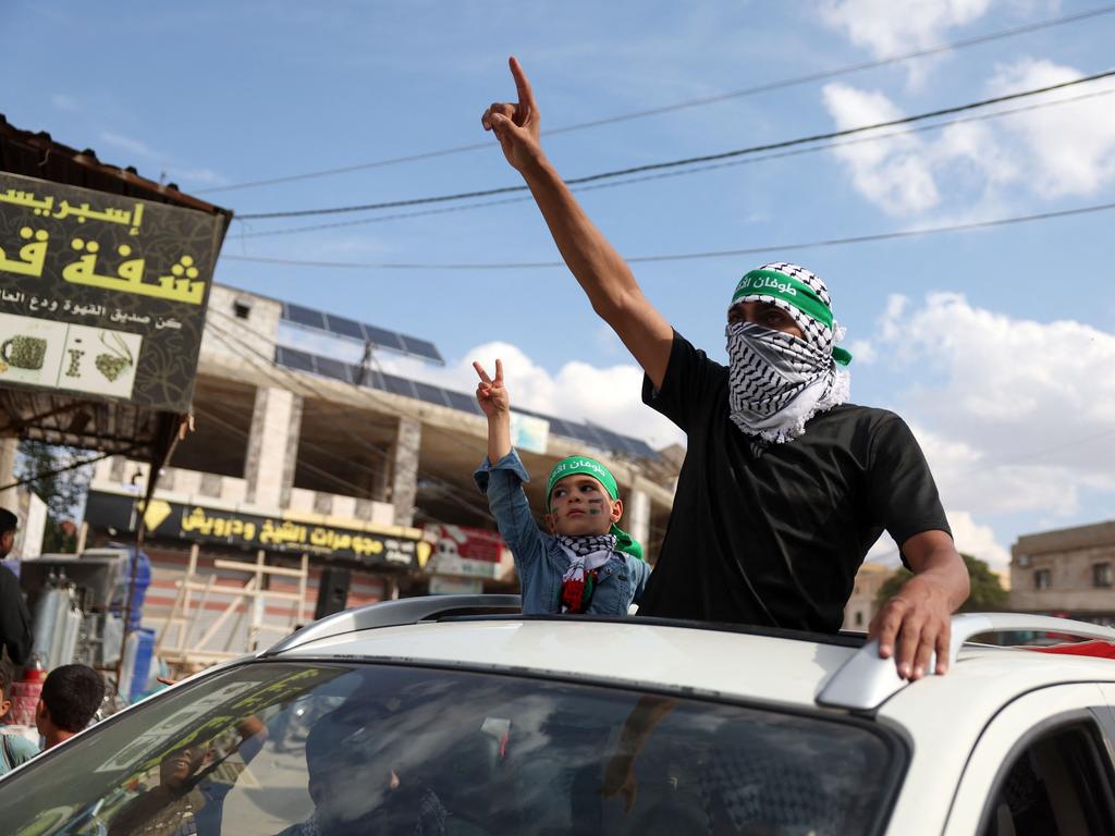 A man and a child take part in a rally in support of Palestinians in the Gaza Strip, in the rebel-held town of Atme in Syria’s northwestern Idlib province. Picture: AFP