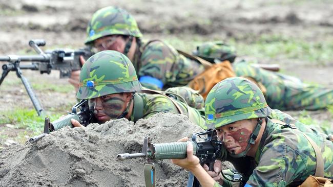 Armed Taiwanese reservists aiming at a target during a military drill. Picture: AFP