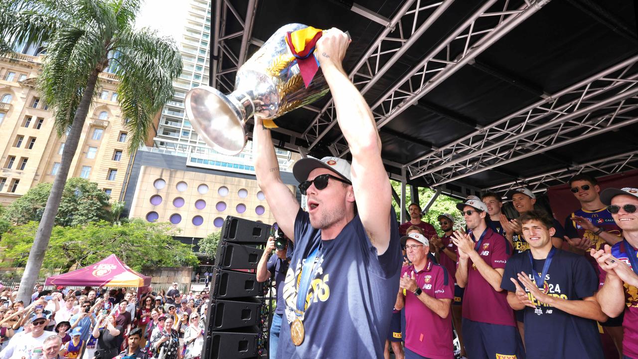 Lachie Neale holds the premiership cup aloft. Picture: Steve Pohlner