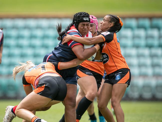 Katie Stevens (left) and Tiana-Lee Thorne tackle Roosters player Phoenix Lamese. Picture: Julian Andrews