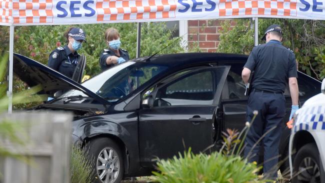 Police inspect a vehicle at Salford court. Picture: Tony Gough