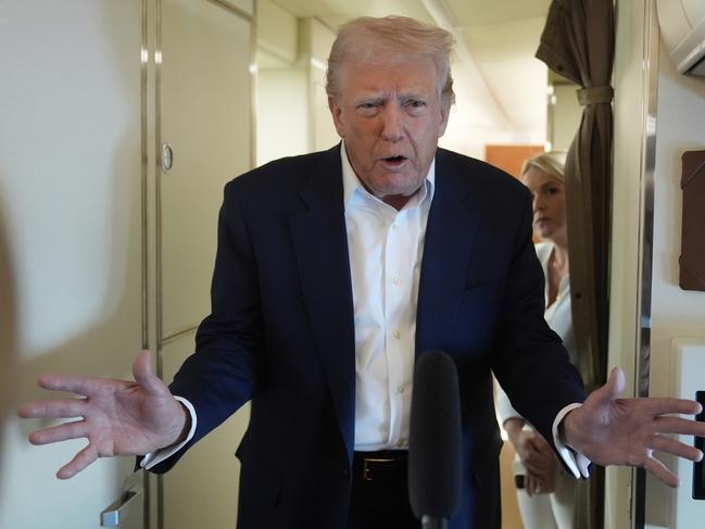 Donald Trump talks with reporters on Air Force One. Picture: AP