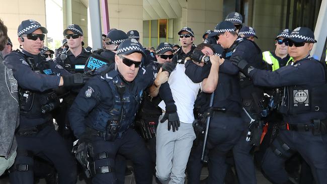 Police escort a protester away from the protest Picture: Alex Coppel.