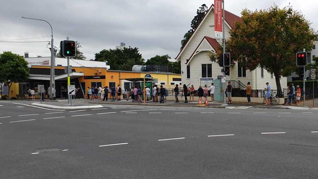 Queues formed outside the Annerley Road Centrelink after the announcement by Prime Minister Scott Morrison on Sunday night. The line continued to grow until it was around the corner. . Picture: Kieran Bicheno