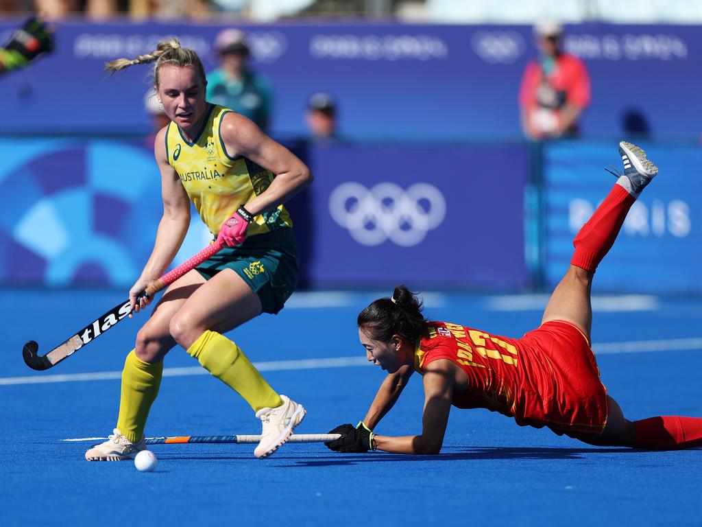 PARIS, FRANCE - AUGUST 05: Jane Claxton of Team Australia controls the ball as Wen Dan of Team People's Republic of China goes down during the Quarter Final Women's match between Australia and People's Republic of China on day ten of the Olympic Games Paris 2024 at Stade Yves Du Manoir on August 05, 2024 in Paris, France. (Photo by Luke Hales/Getty Images)