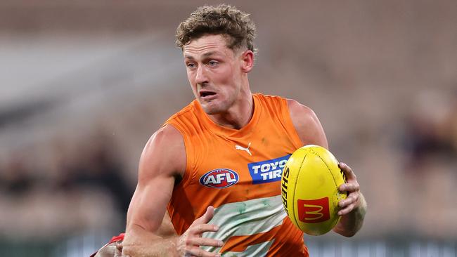 MELBOURNE, JULY 27, 2024: 2024 AFL Football - Round 20 - Melbourne Demons V GWS Giants at the MCG. Harry Perryman of the Giants under pressure from Kysaiah Pickett of the Demons. Picture: Mark Stewart