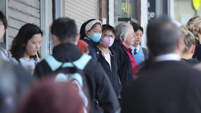 Two people on Elizabeth Street in Surry Hills are seen wearing face masks as they get off a train. Picture: Rohan Kelly