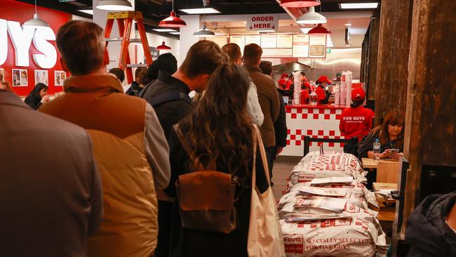 People waiting to order at the opening of cult US fast food franchise Five Guys in the Sydney CBD. Picture: Justin Lloyd