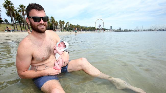 Ballarat dad Cameron introduces four-week-old Saxon to the sea for the first time. Picture: Alan Barber