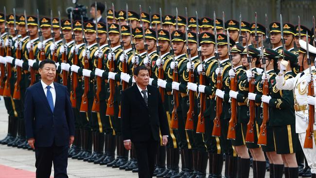 Philippines President Rodrigo Duterte (C) and Chinese President Xi Jinping review the guard of honors as they attend a welcoming ceremony at the Great Hall of the People in Beijing.