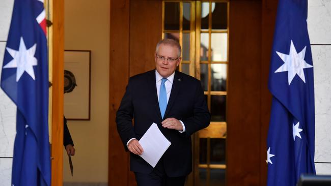 Prime Minister Scott Morrison arrives to speak to the media at a press conference at Parliament House in Canberra on Friday.