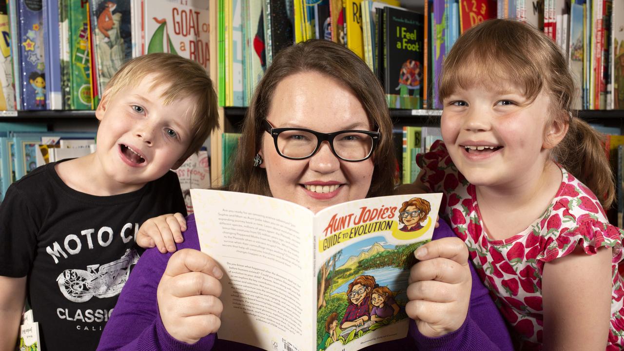 Dr Jordan Bell reading her new book “Aunt Jodie’s Guide to Evolution” to children including her daughter Ruby, 6, and Hamish, 6 in the children’s corner at “Booked” in North Adelaide. Picture: Emma Brasier