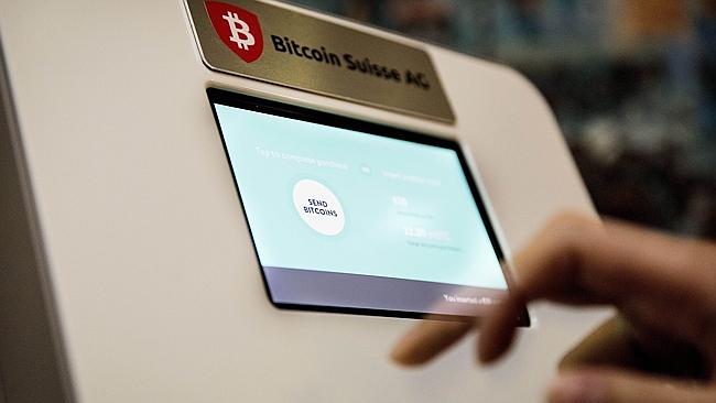 A person uses a bitcoin ATM machine in a restaurant in The Hague. AFP/VALERIE KUYPERS