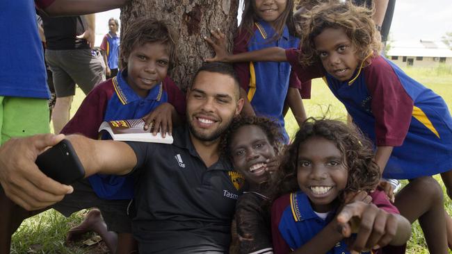 Jarmin Impey takes a selfie with some excited kids at Wugularr School at Beswick in the Northern Territory. Picture: Michael Klein