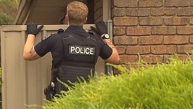 Heavily armed STAR Group officers have swooped on a home at Reynella East, arresting an alleged gunman. Picture: 7NEWS