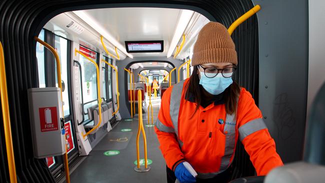 A member of the Sydney light rail cleaning team wears a face mask at Randwick Station. Picture: Getty Images