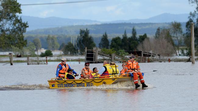 SES volunteers continue to move stranded residents and vital supplies by boat.