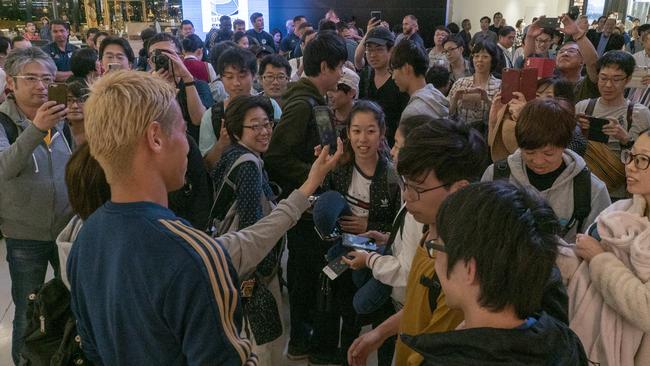 Keisuke Honda was swamped by fans on arrival in Japan. 