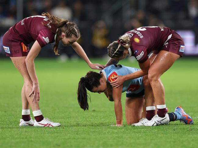 Tamika Upton and Julia Robinson check on the injured Isabelle Kelly in game one. Picture: Mark Kolbe/Getty Images