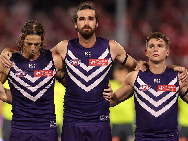 Nat Fyfe, Alex Pearce and Caleb Serong during the moment’s silence for Cam McCarthy on Friday night. Picture: Paul Kane/Getty Images.