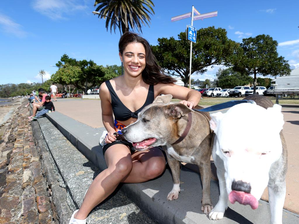 Betty Harrison with pups Sapphira and Kelsey, from Fortitude Valley at Sandgate Beach. Picture: Steve Pohlner