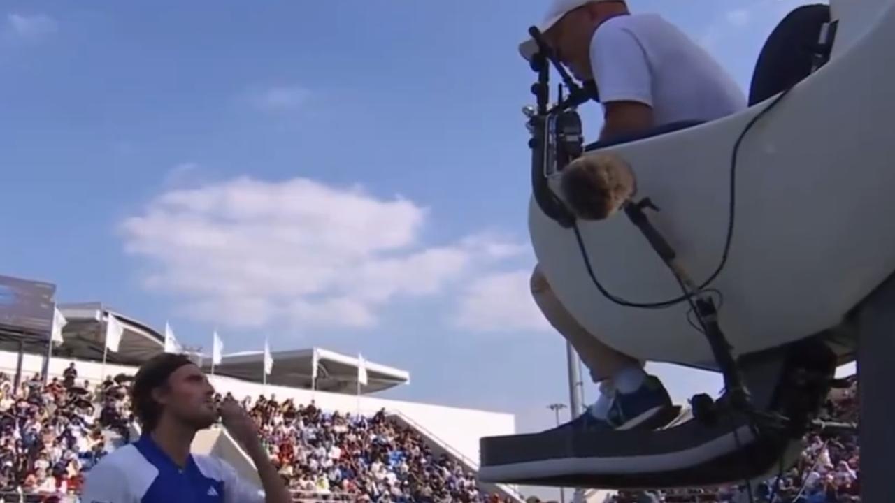 Stefanos Tsitsipas argues with the chair umpire.