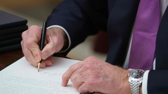 US President Joe Biden signs a flurry of executive orders, some undoing Trump decisions, within hours of taking office. Picture: Mandel Ngan/AFP