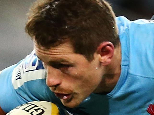 SYDNEY, AUSTRALIA - JUNE 28: Bernard Foley of the Waratahs is tackled during the round 17 Super Rugby match between the Waratahs and the Brumbies at ANZ Stadium on June 28, 2014 in Sydney, Australia. (Photo by Mark Nolan/Getty Images)