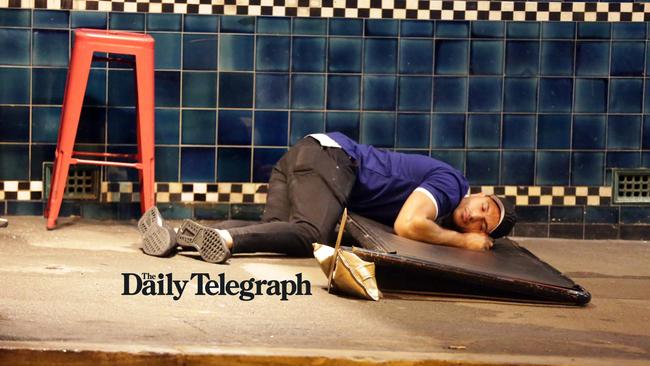 Pictured is a Bulldogs player on the ground after falling asleep during Mad Monday celebrations at The Rocks. Picture: Christian Gilles