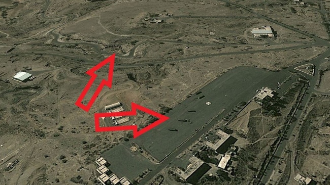 This 2011 Google Maps satellite image shows ballistic-missile carrying trucks parked at a Houthi facility on the outskirts of the city of Sanaa. Analysts have since identified a new underground storage facility cut into a nearby cliff face. Source: Google Maps.