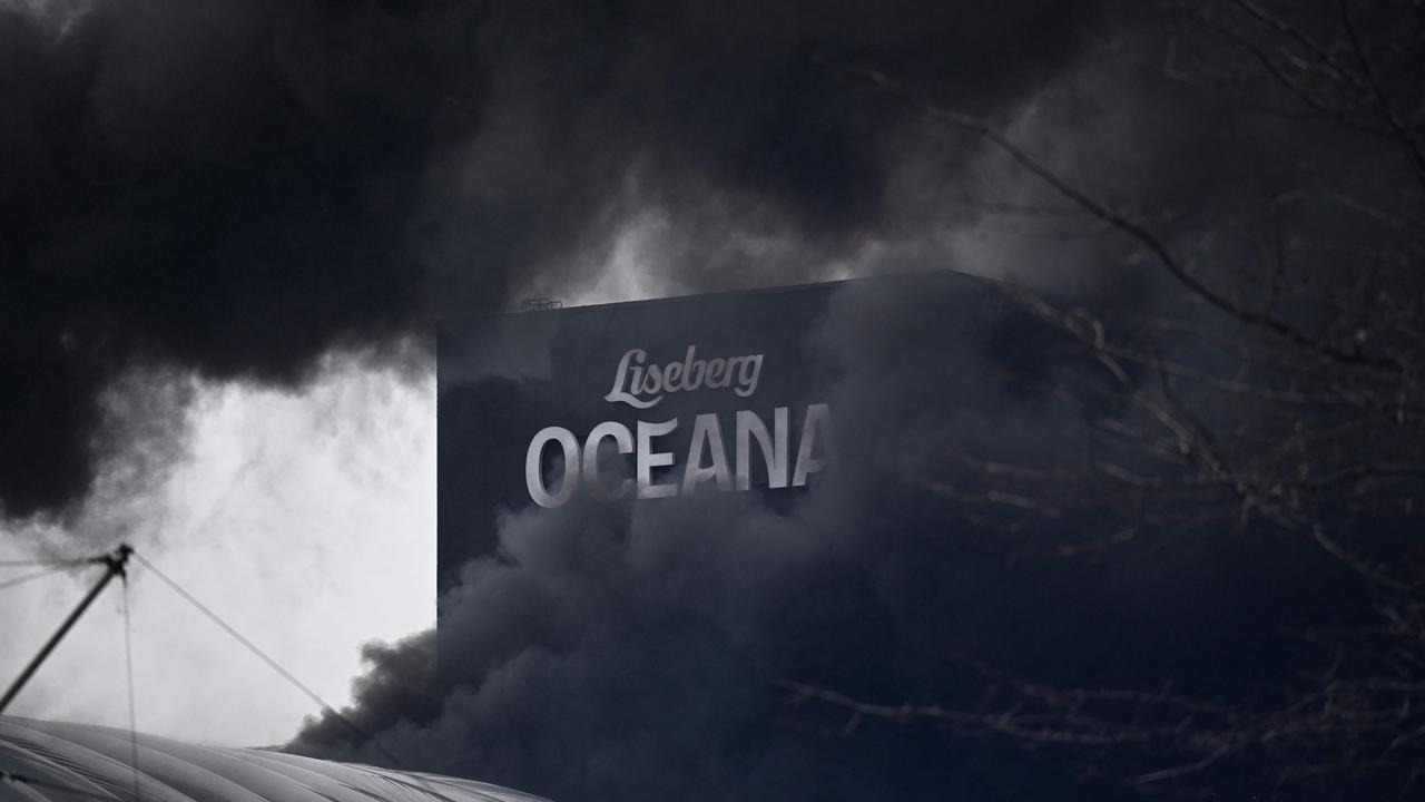 Billows of smoke are picture at a structure of the Oceana Waterworld at the Liseberg Amusement Park in Gothenburg, Sweden on February 12, 2024. (Photo by Born LARSSON ROSVALL / TT News Agency / AFP)