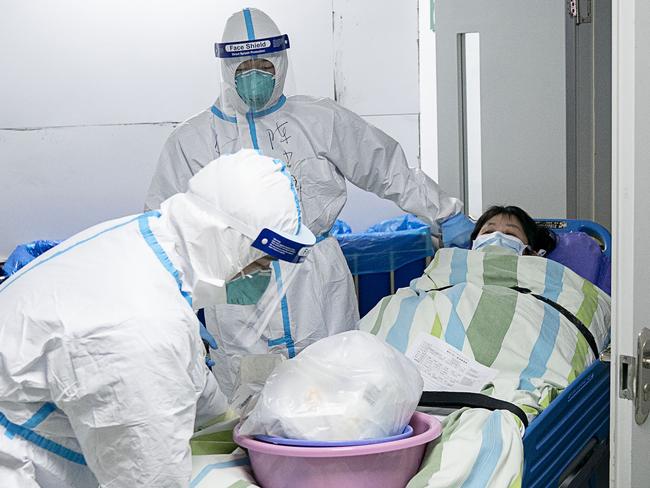 In this Friday, Jan. 24, 2020, photo released by China's Xinhua News Agency, a medical workers transfer a patient out of the intensive care unit at Zhongnan Hospital of Wuhan University in Wuhan in central China's Hubei Province. China expanded its lockdown against the deadly new virus to an unprecedented 36 million people and rushed to build a prefabricated, 1,000-bed hospital for victims Friday as the outbreak cast a pall over Lunar New Year, the country's biggest, most festive holiday. (Xiong Qi/Xinhua via AP)