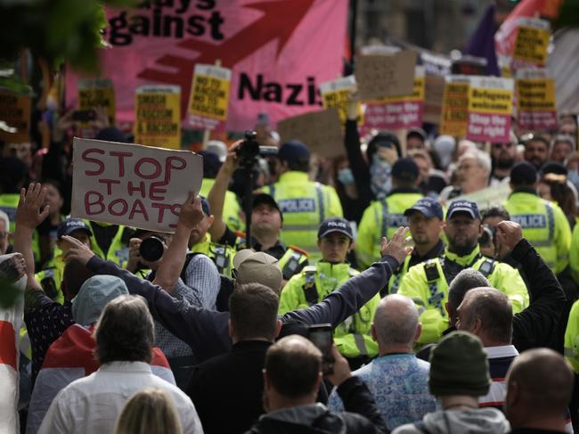 Police form a divide between people taking part in an anti-racism counter protest, (behind) and far-right activists (foreground) protesting at Piccadilly Gardens on August 3. Picture: Getty Images