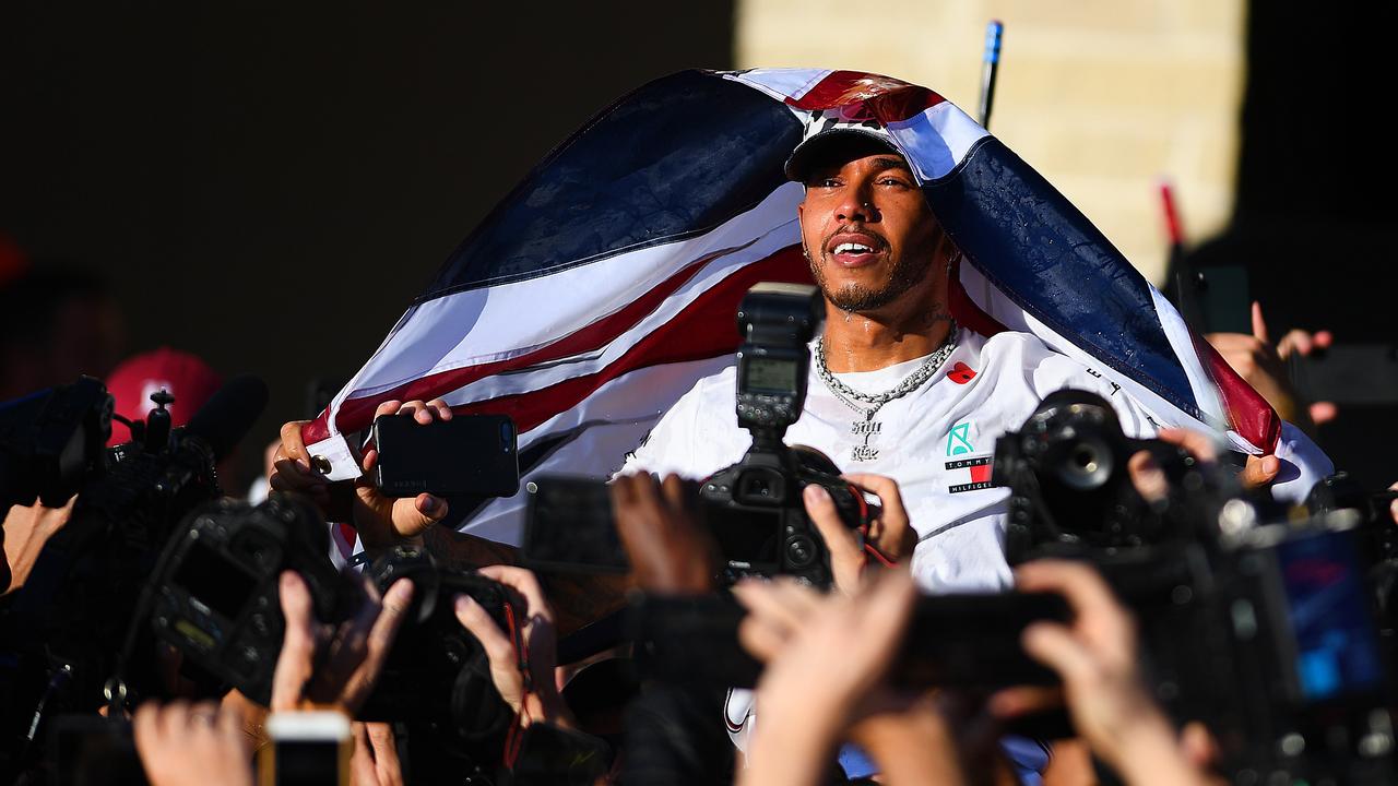 Lewis Hamilton celebrates after claiming title No. 6. Picture: Clive Mason