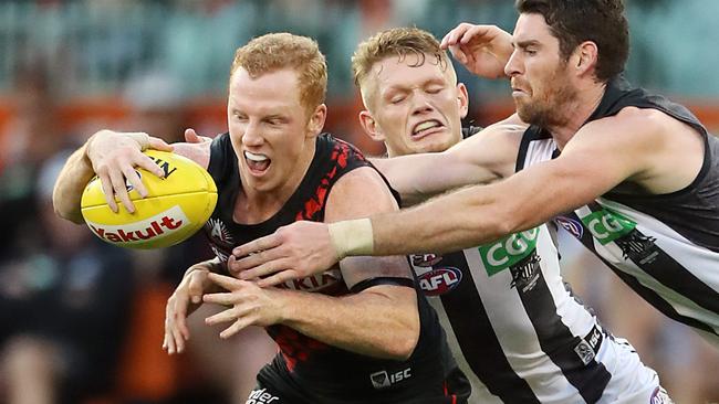 AFL Anzac Day clash between Essendon and Collingwood at the MCG in Melbourne. Josh Green tackled by Tyson Goldsack. Picture: Alex Coppel.