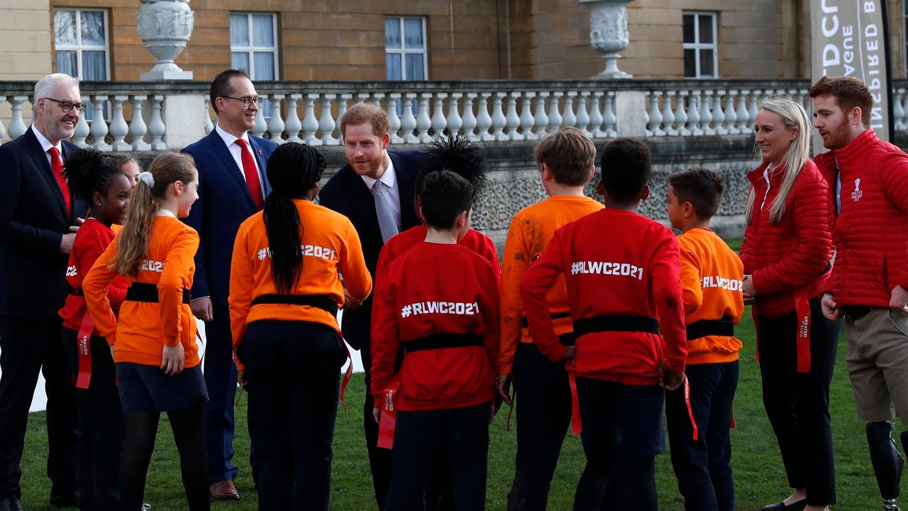 Harry chatted with children playing rugby league prior to the draw. Picture: Adrian Dennis/AFP