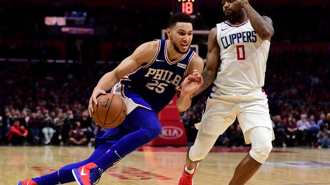 Ben Simmons #25 of the Philadelphia 76ers drives on Sindarius Thornwell #0 of the LA Clippers the LA Clippers during a 109-105 win over the Clippers at Staples Center on November 13, 2017 in Los Angeles, California. Harry How/Getty Images
