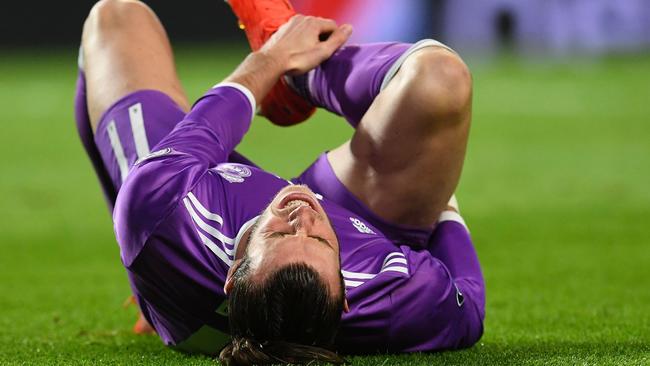 Real Madrid's Welsh forward Gareth Bale grimaces as he lies on the pitch during the UEFA Champions League football match against Sporting CP.