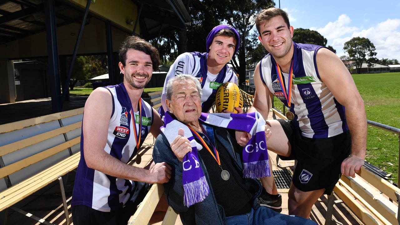 Luke - 21yrs, Ray Semmler with his 3 grandsons, Jake - 23yrs and Brad - 28yrs Johansen pose for a photograph at the Henley Sharks FC, Henley Beach, Adelaide on Saturday the 21st of September 2019. The 3 brothers play Divison 4 with CBC Old Collegians and won the Grand Final against Edwardstown last week. Jake quit the SANFL club Woodville-West Torrens mid-season and promised his sick grandfather (who is still alive but wasn't well) that he would play footy with his brothers. (AAP Image/Keryn Stevens)