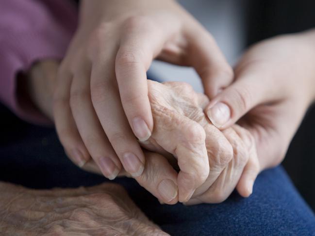 Aged persons hands held by young hands. Pic is Istock image. One time use only.