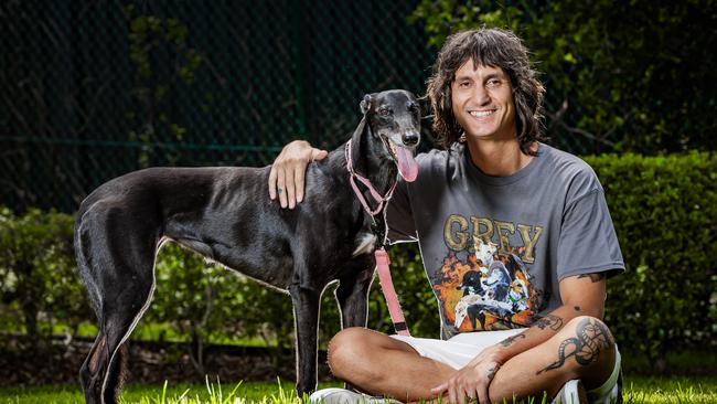 Filmmaker Indy Davies with his greyhound Georgie at their home in Robina, Queensland. Picture: Nigel Hallett