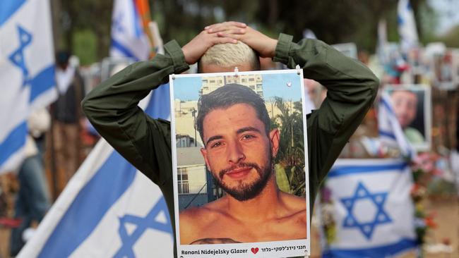 A visitor mourns at a memorial for people who were taken hostage or killed in the Hamas attack on the Supernova music festival on October 7. Picture: AFP