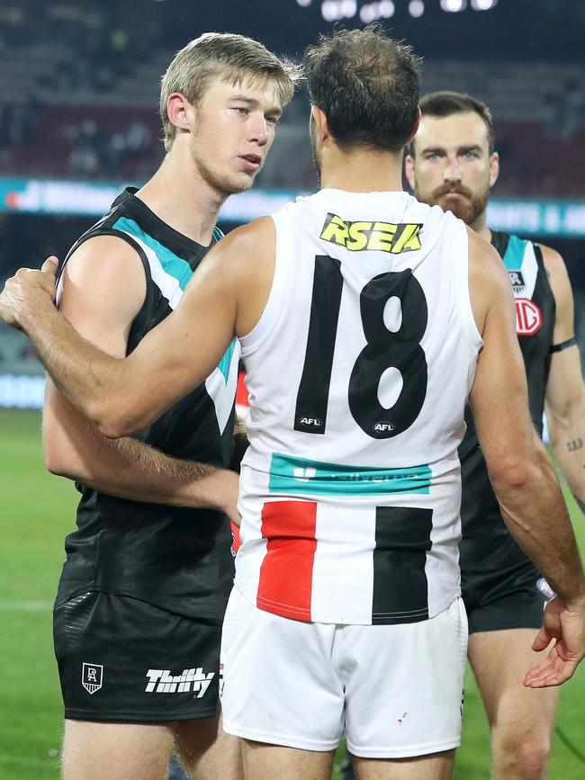 … and speaks with former teammate and close friend Paddy Ryder after the match.