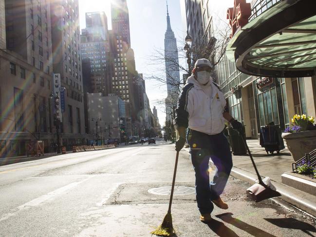 NEW YORK, NY - APRIL 06: A woman cleans on 34th street on April 6, 2020 in New York City. The COVID-19 death toll in the U.S. is approaching 10,000.   Kena Betancur/Getty Images/AFP == FOR NEWSPAPERS, INTERNET, TELCOS & TELEVISION USE ONLY ==