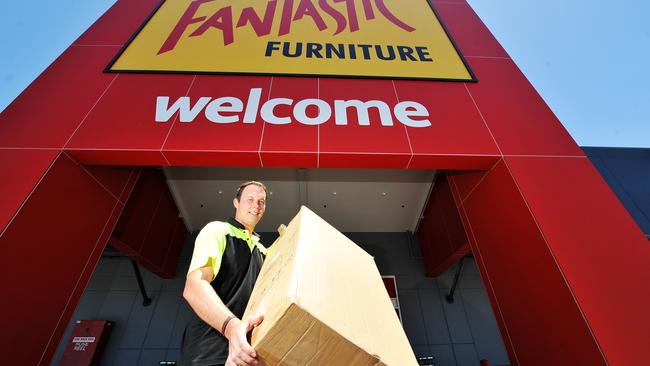 Storeman Ian Smith loads at the Fantastic furniture store in Townsville.